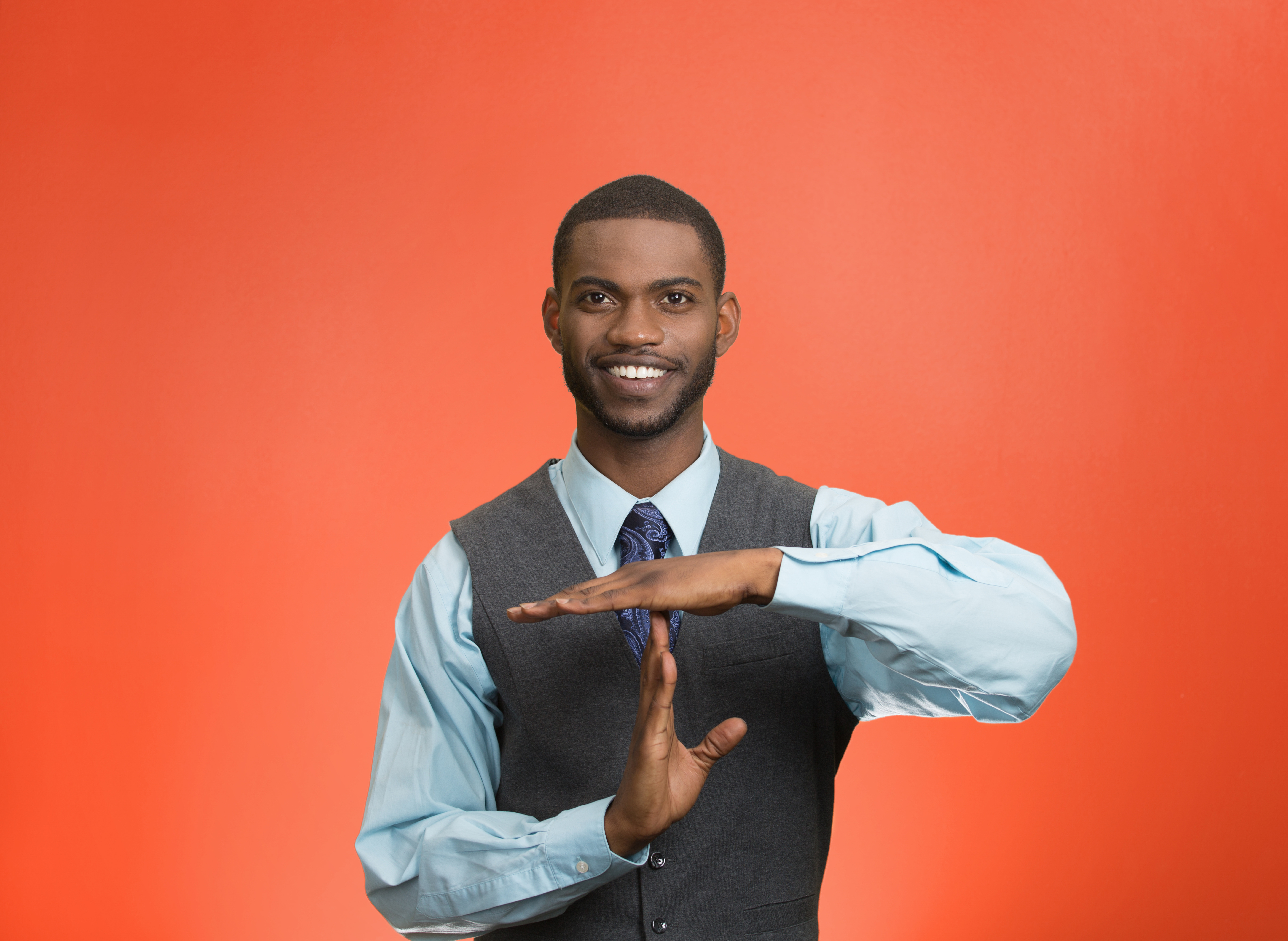 Executive man giving time out gesture with hands